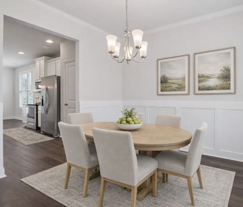 A dining room with a table set for four.