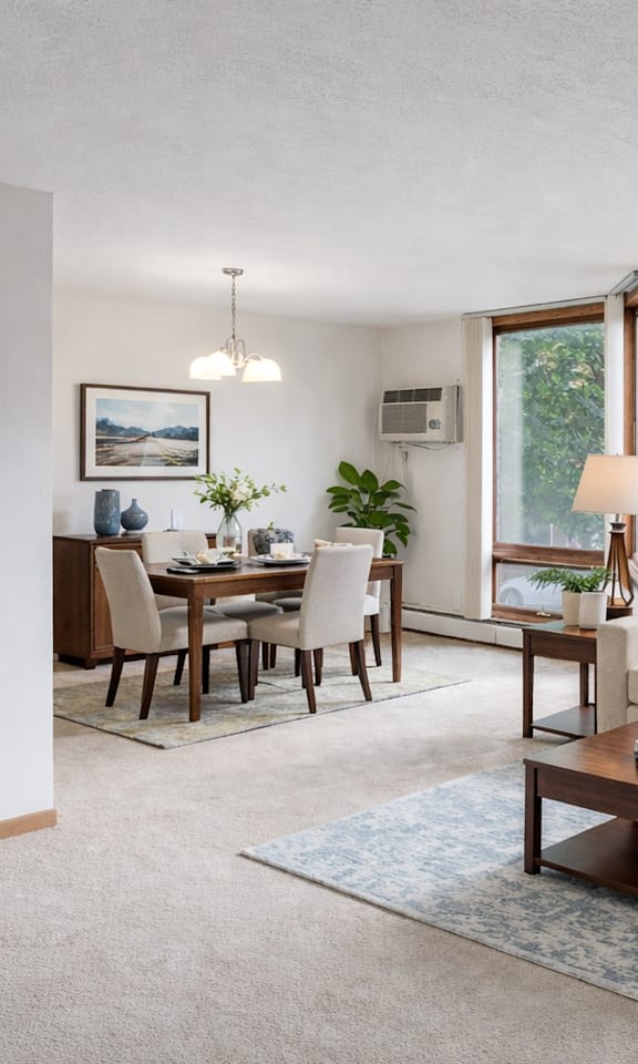 A living room with a couch, coffee table, and dining table.