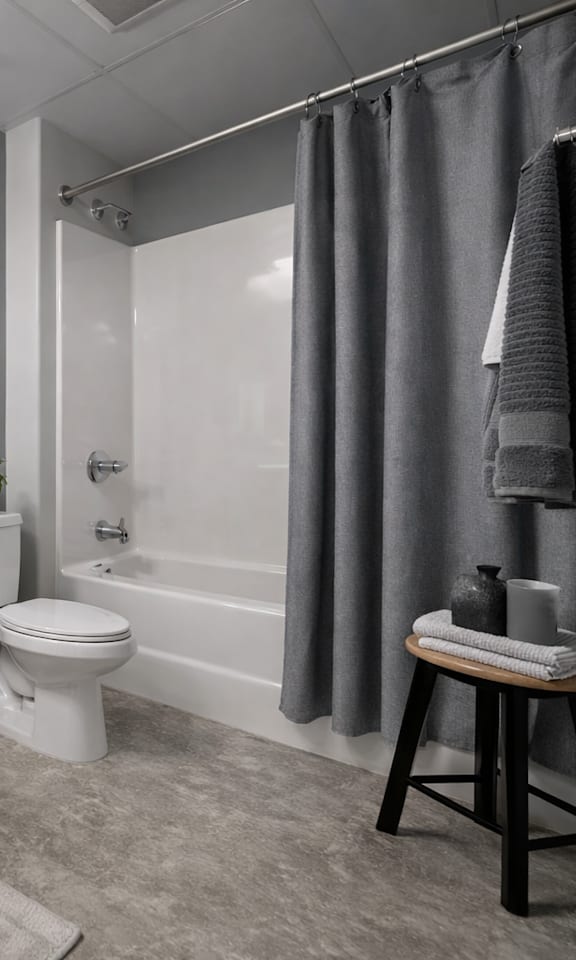 A bathroom with a toilet, sink, and bathtub.