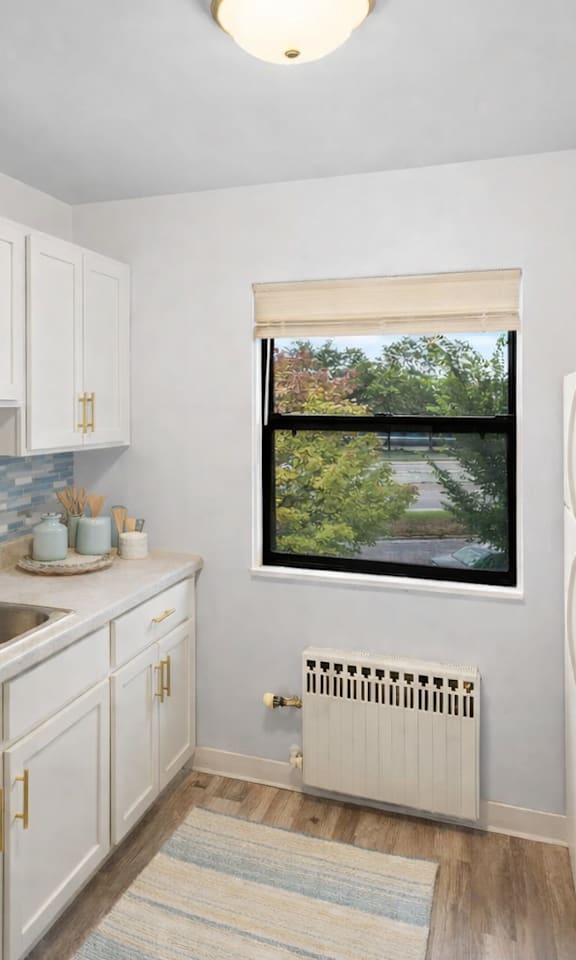 A kitchen with a window overlooking a bridge.