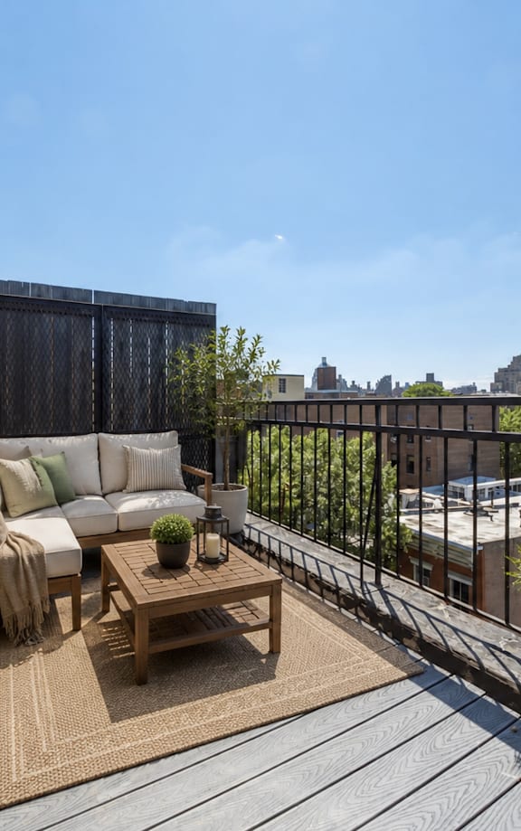 A balcony with a table and chairs is shown.