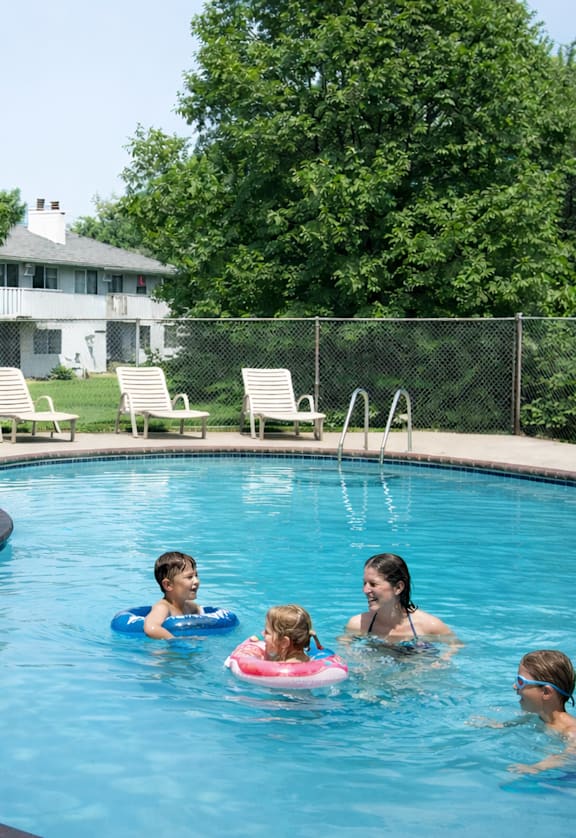 A group of people are enjoying a swim in a pool.