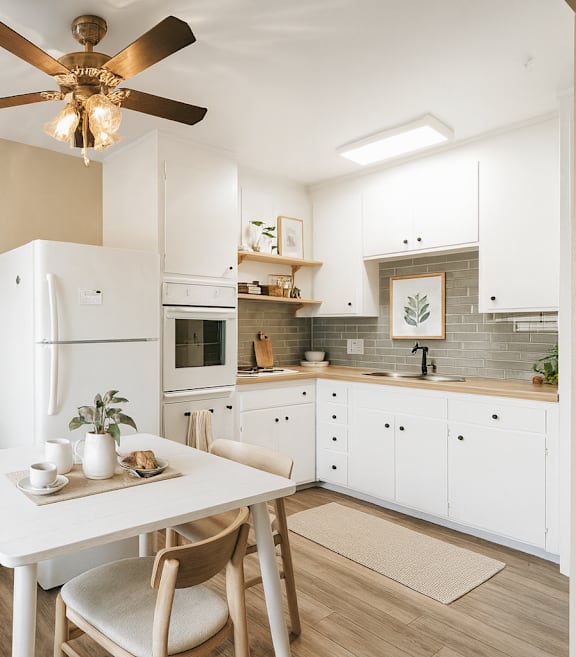 A kitchen with a white chair and a ceiling fan.