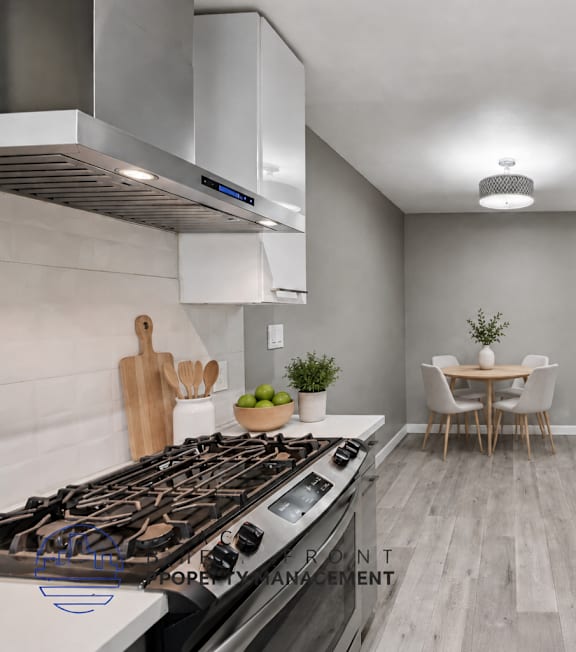A well-lit, modern kitchen and living room with a dining area.
