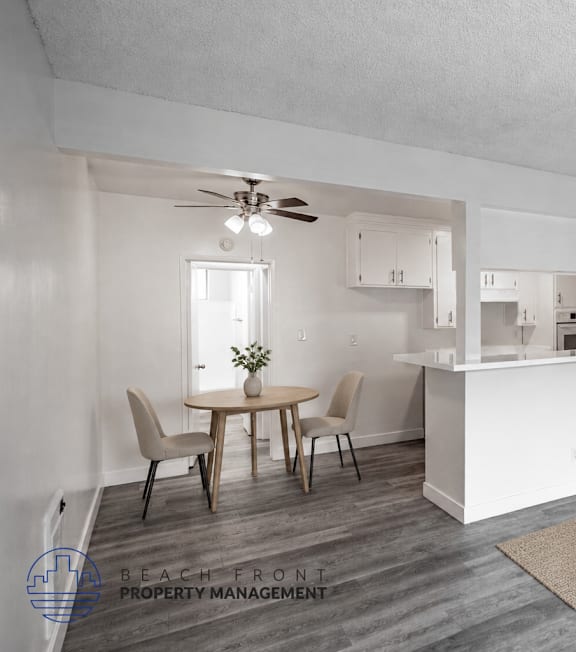 A well-lit, modern kitchen and living room with a dining area.