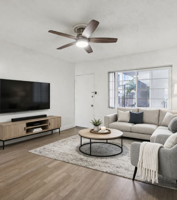 A well-lit, modern kitchen and living room with a dining area.