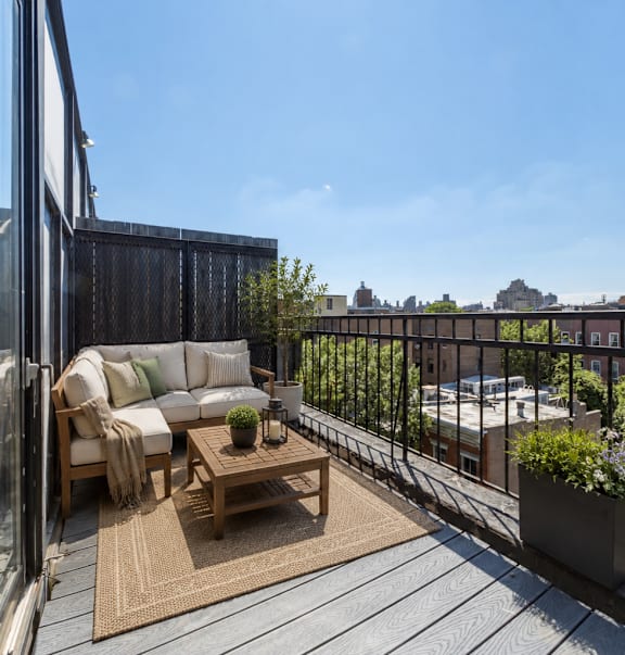 A balcony with a table and chairs is shown.