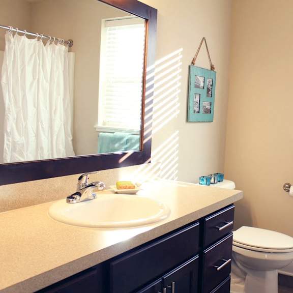 A room with a ceiling fan and a window overlooking a construction site.