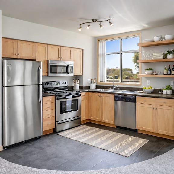 A kitchen with a black stove top oven and a black microwave above it.
