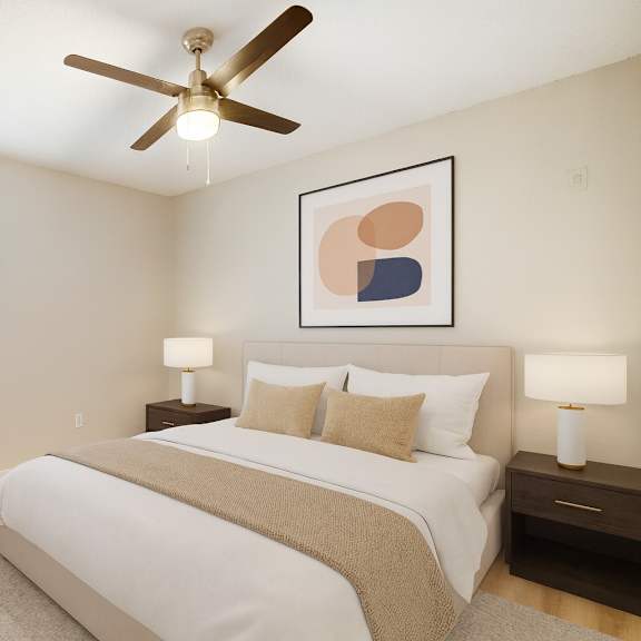 A bedroom with a bed, two lamps, and a ceiling fan.