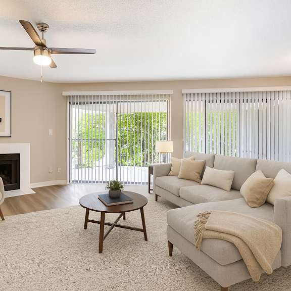 A living room with a fireplace, a chair, a couch, and a coffee table.