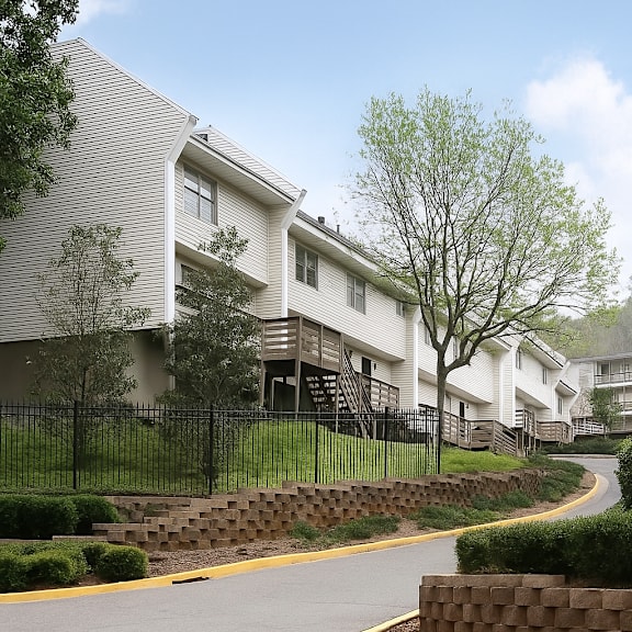 A residential area with houses and a curved road.