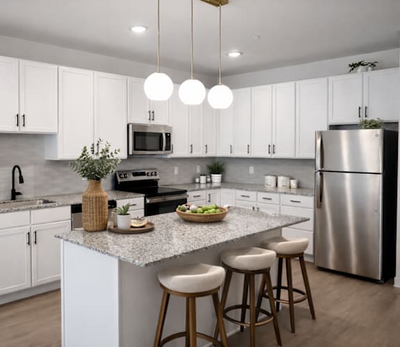 A modern kitchen with a large island and stools.