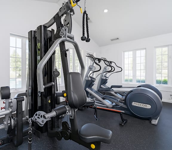 A gym with a variety of equipment including a leg press machine.