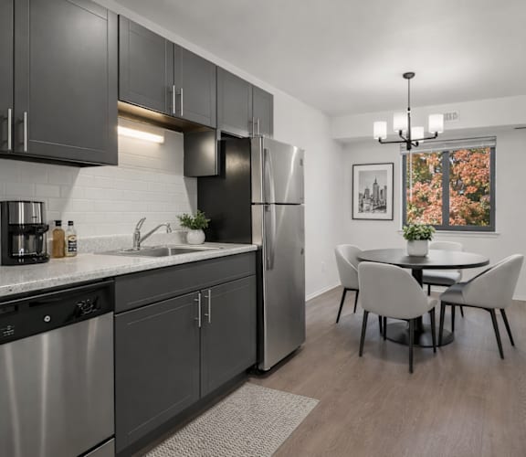 A modern kitchen with a dining table and chairs.
