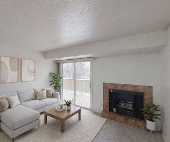 A spacious cozy kitchen with white appliances, kitchen utensils, overhead lighting, light countertops with lots of room, a bar counter with two places set, and large wooden cabinets at Russian Jack Apartment Homes. 