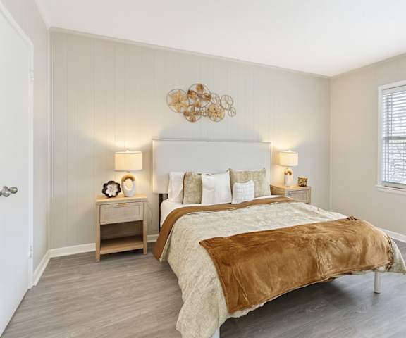 A bedroom with a large bed and a chandelier.