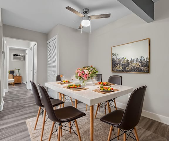 A dining room with a table set for four.