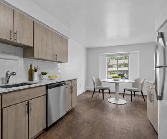 A kitchen with wooden cabinets and a white fridge.