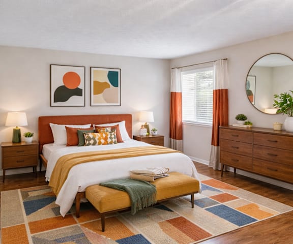 A bedroom with a bed, nightstands, and a dresser.