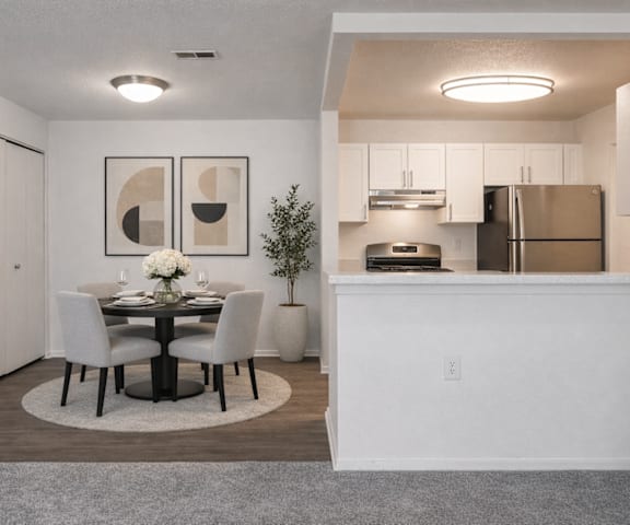 A modern dining room with a table set for two.