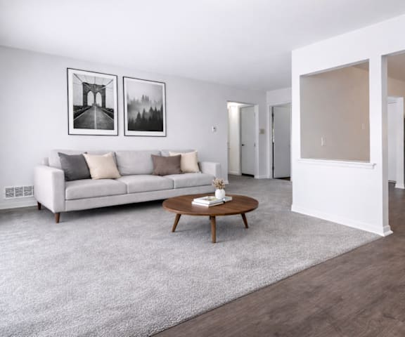 A modern living room with a white couch and a coffee table.