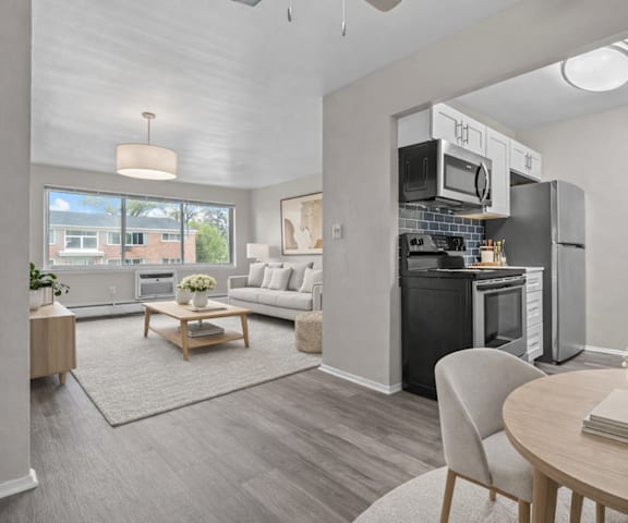 A modern kitchen with a dining table set for two.