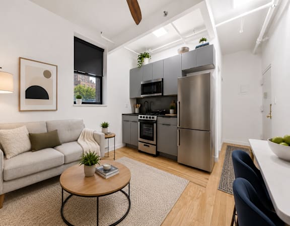 A modern kitchen with a refrigerator, oven, and microwave.
