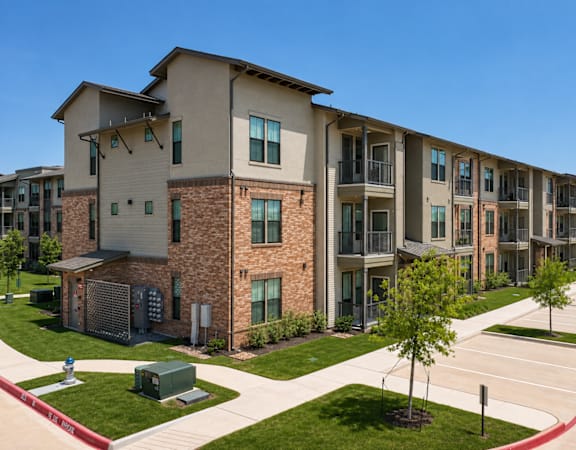 Modern apartment homes with private balconies, landscaped grounds, and reserved parking at One Preston Station.