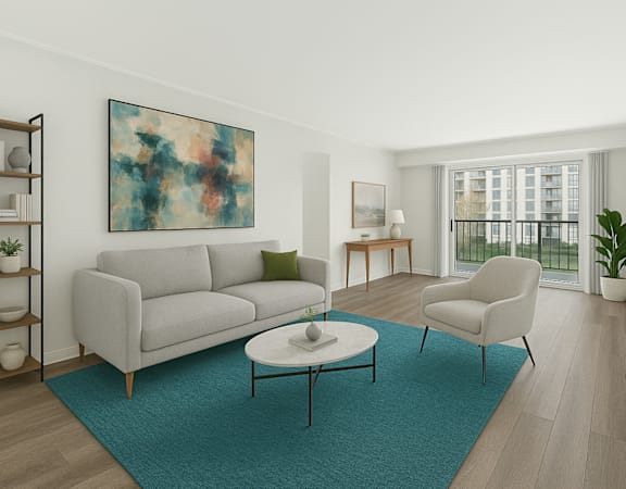 A living room with a grey couch, a blue rug, a coffee table, a chair, a bookshelf, and a painting on the wall.