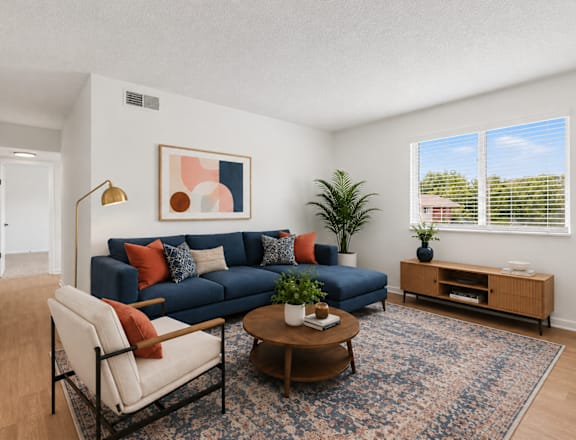 A living room with a blue sofa and a coffee table.