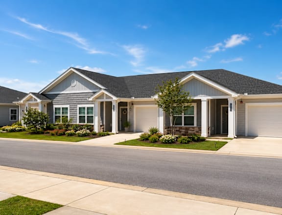 A house with a grey roof and white garage door.