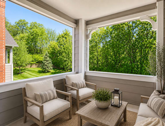 A sunny day in a cozy balcony with a table and two chairs.