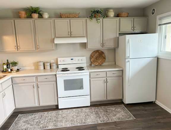 A modern kitchen with a large island and stainless steel appliances.
