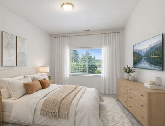 A bedroom with a large bed, a window with a view of trees, and a painting on the wall.