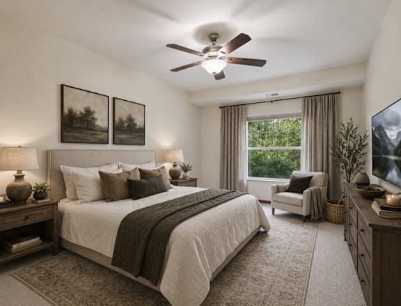 A bedroom with a large bed, a ceiling fan, and a television.