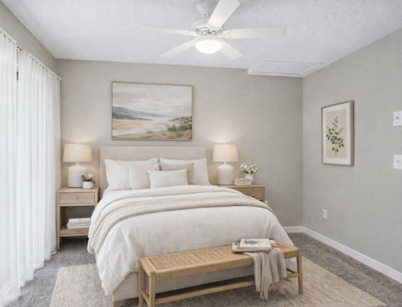A bedroom with a large bed, a nightstand, and a painting on the wall.