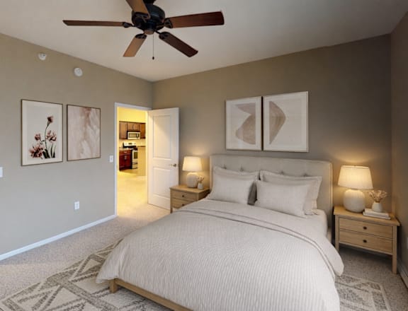 A bedroom with a large bed and a ceiling fan.