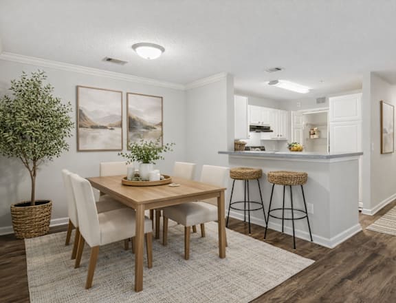 A dining room with a table and chairs.