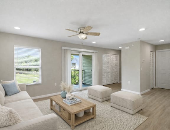 A living room with a white couch and a wooden coffee table.