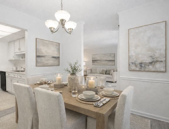 A dining room with a table set for two with candles on the table.