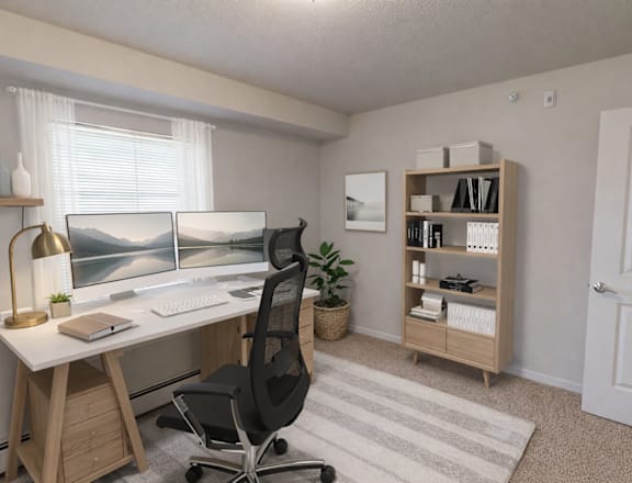 A home office with a desk, chair, and bookshelf.