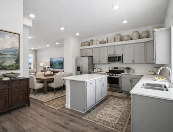 A modern kitchen with a dining table and chairs in the middle.
