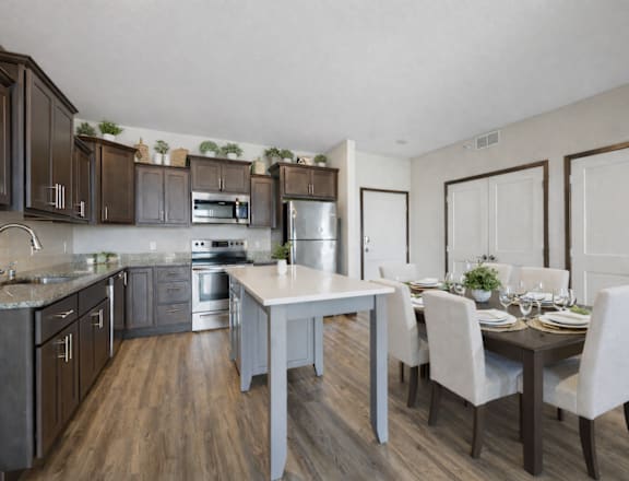 A modern kitchen with dark wood cabinets and a white island.