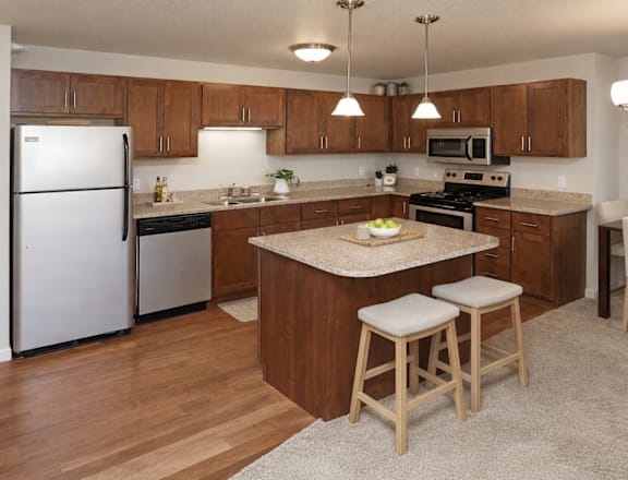 A kitchen with wooden cabinets and a white refrigerator.