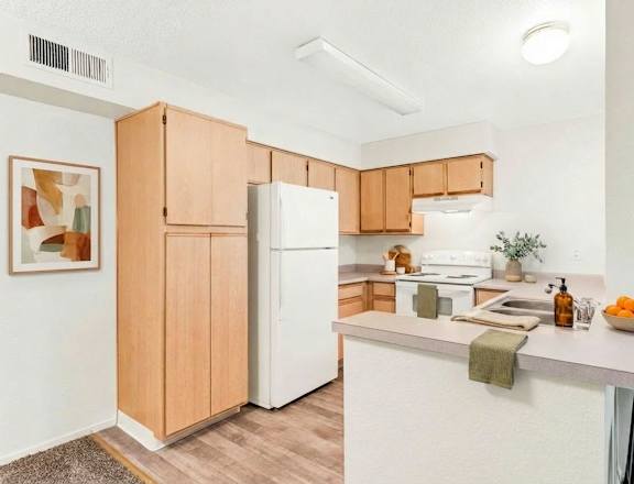 A kitchen with white cabinets and a black stove top oven.