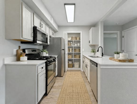 A kitchen with white cabinets and appliances. at Waterbridge Apartments , Orlando, FL, 32837
