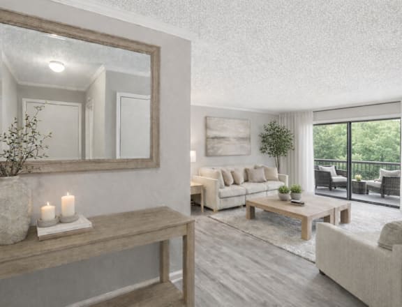 A living room with a large mirror, a wooden bench, and a vase with candles on it.