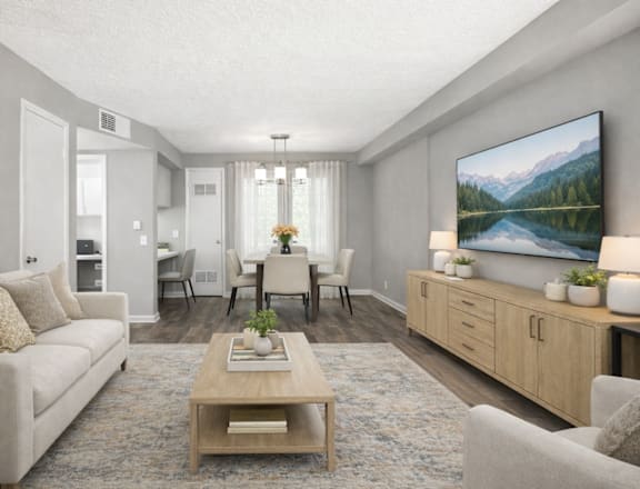 A living room with a large painting on the wall and a coffee table in the center.