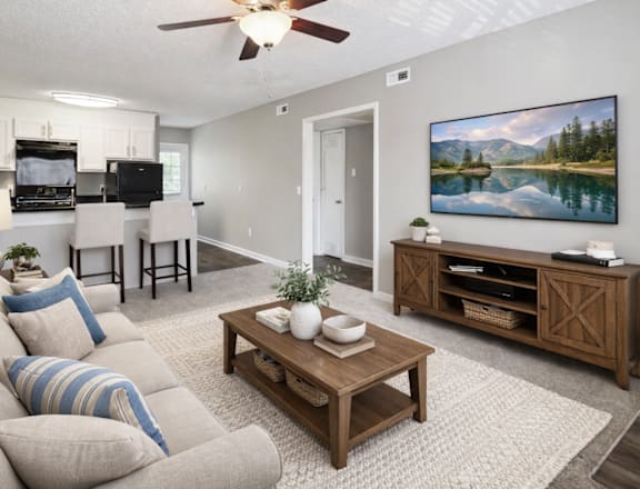 A living room with a wooden coffee table and grey couches.